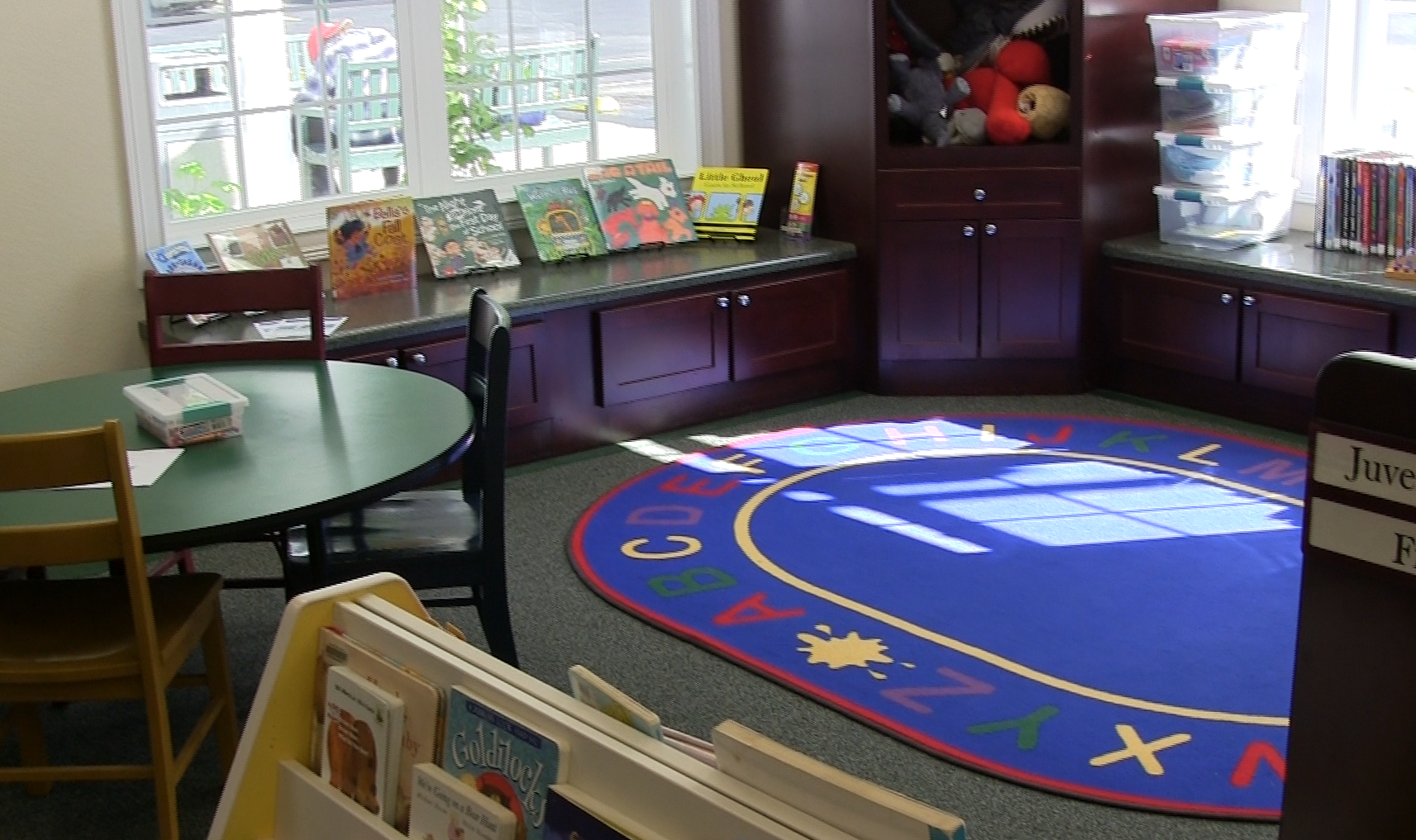 Childrens books and a colorful rug