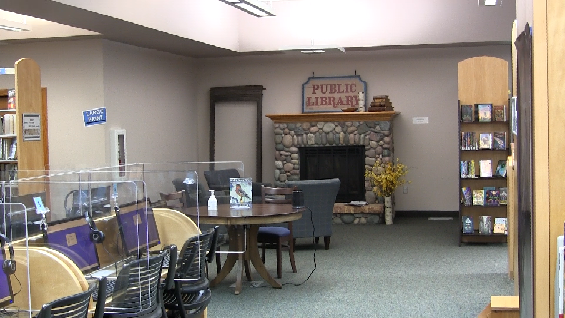 Library with computers and stone fireplace