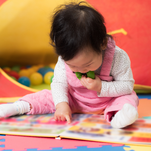 Baby looking at a book