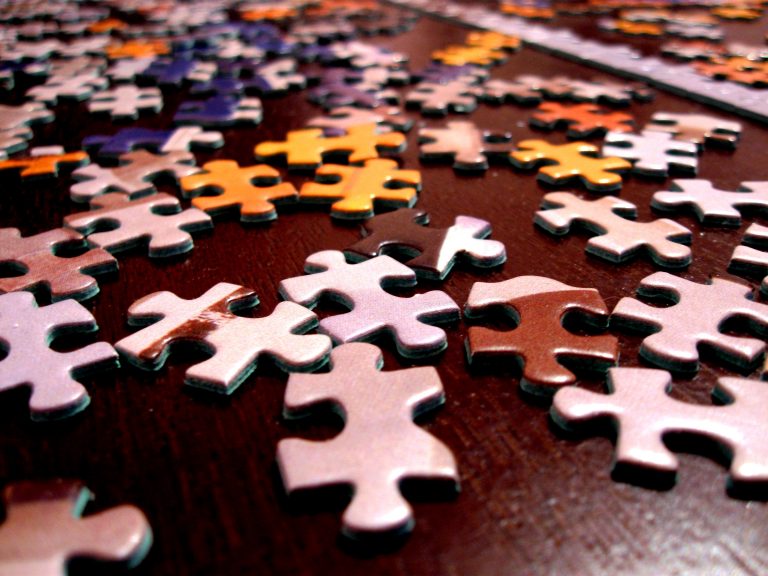 multicolored puzzle pieces on a brown surface