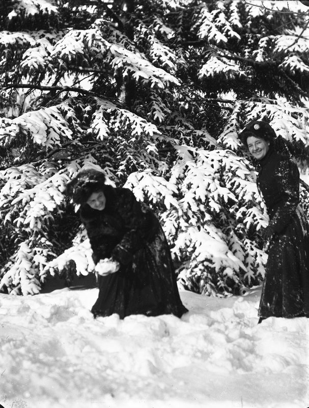 Two ladies having a snowball fight