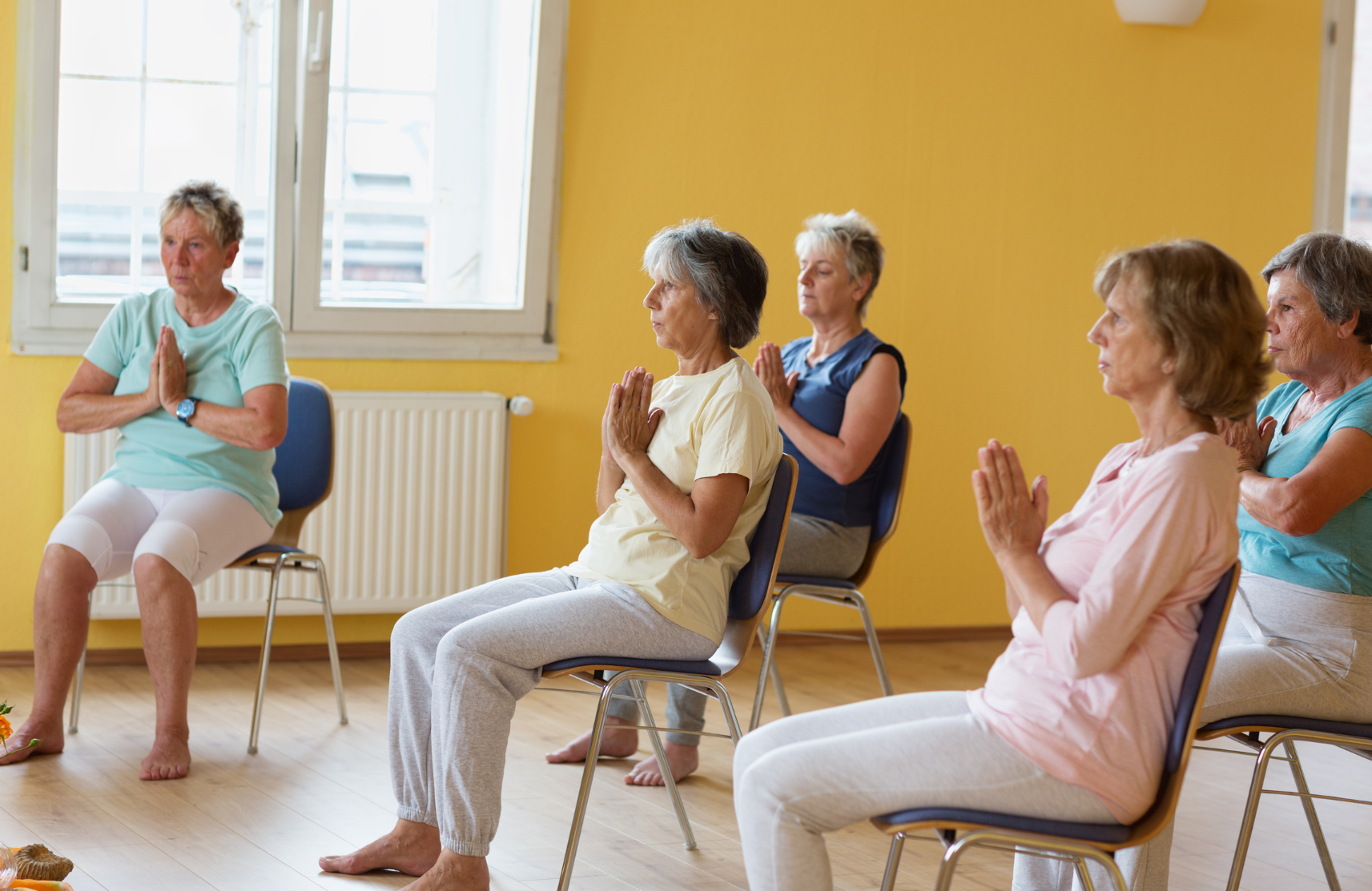 People in chairs doing yoga