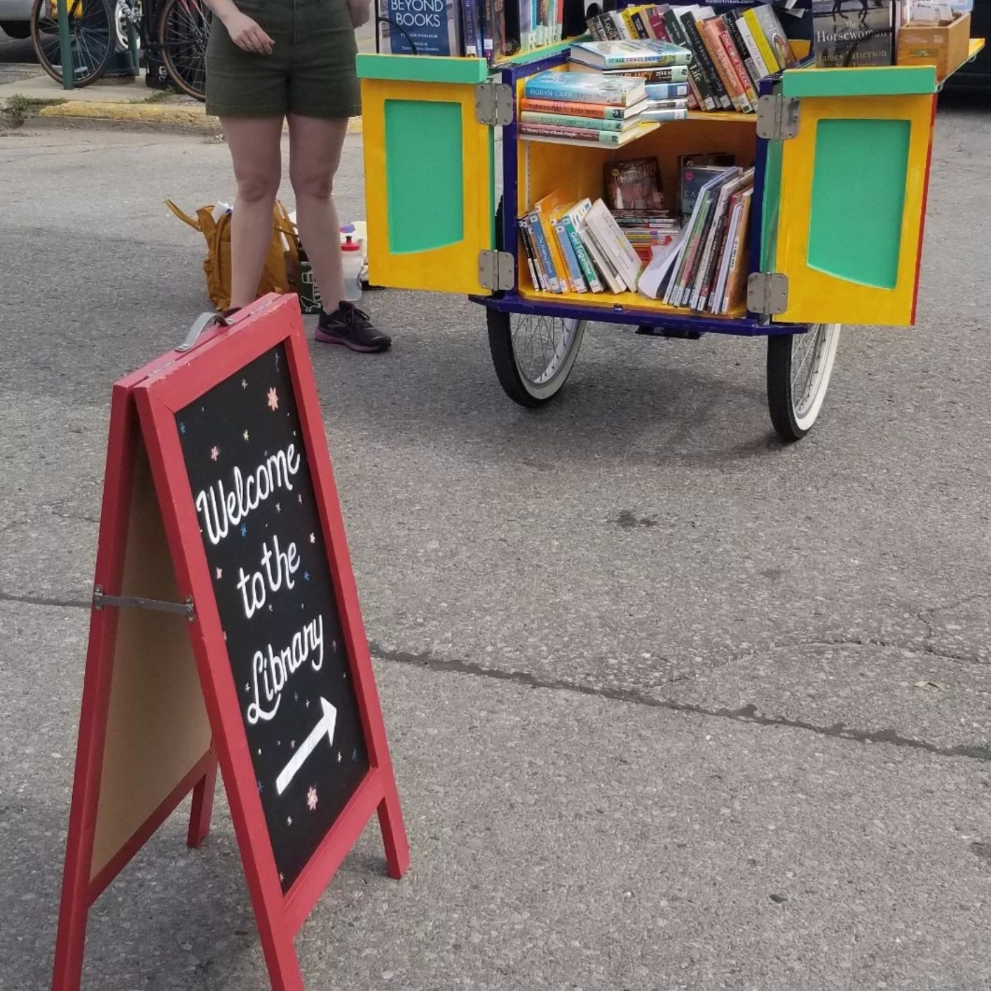 Library Book Bike with welcome to the library sign