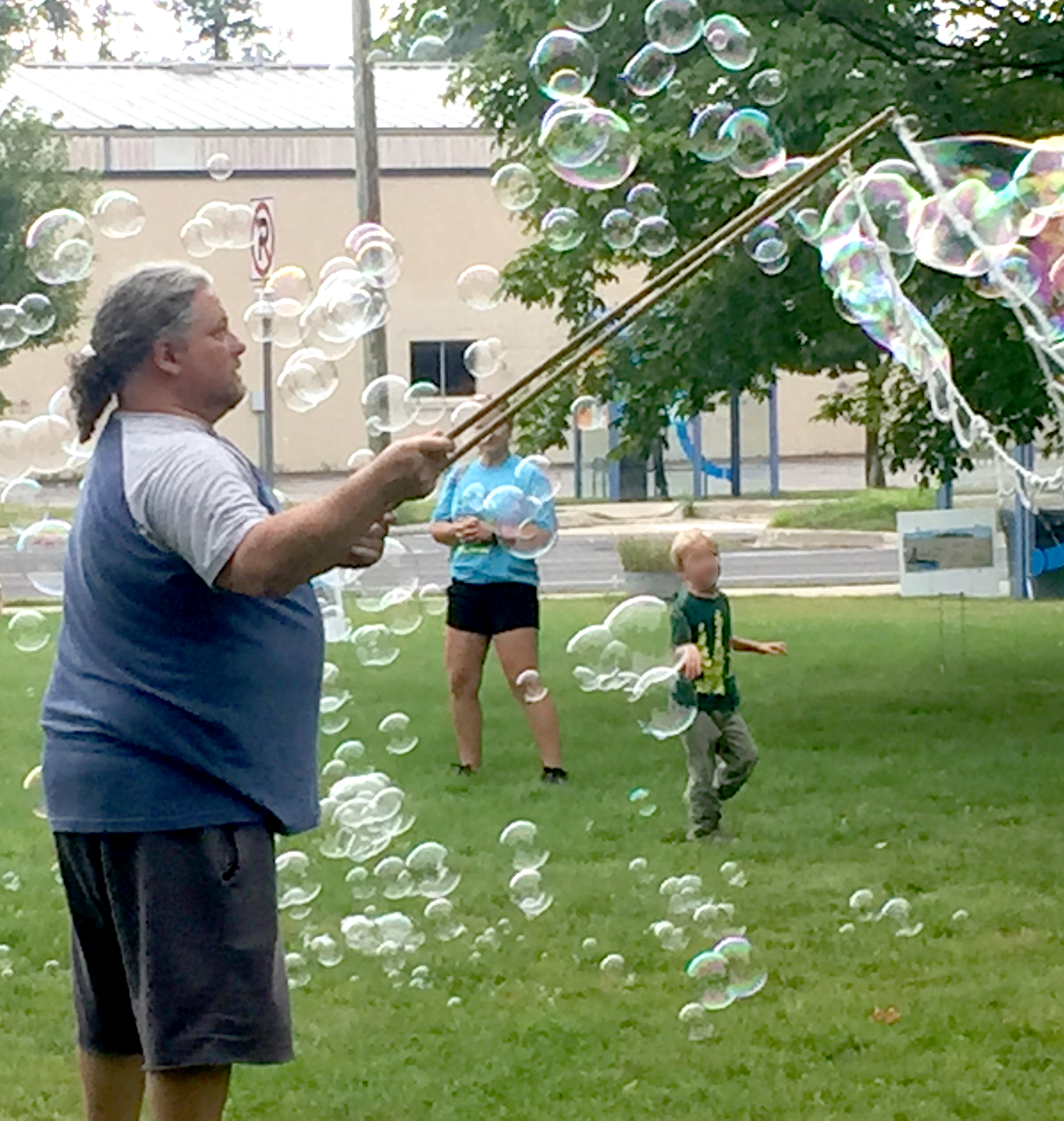 Bubbleman making giant bubbles on the Main Library front lawn