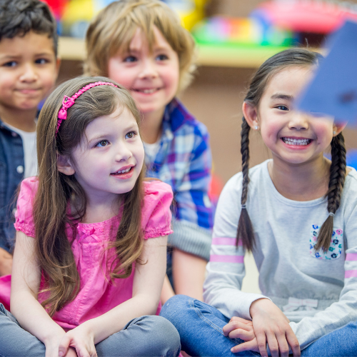 Children sitting on the floor listening to a story