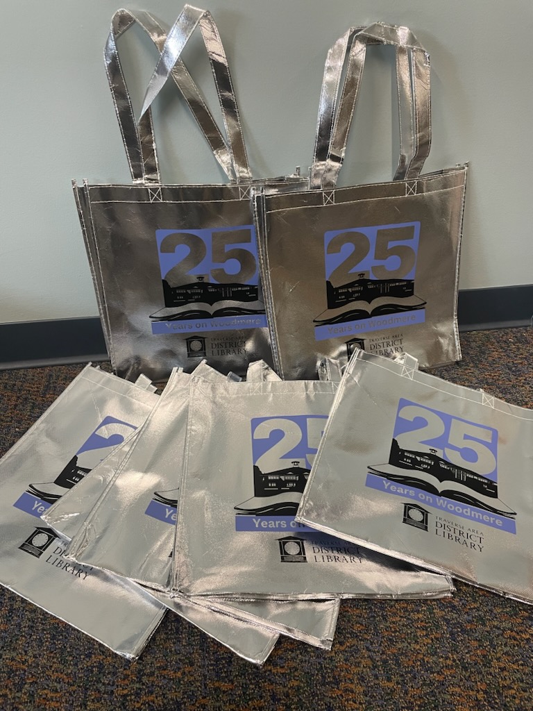 Silver tote bags with the Woodmere 25th anniversary logo