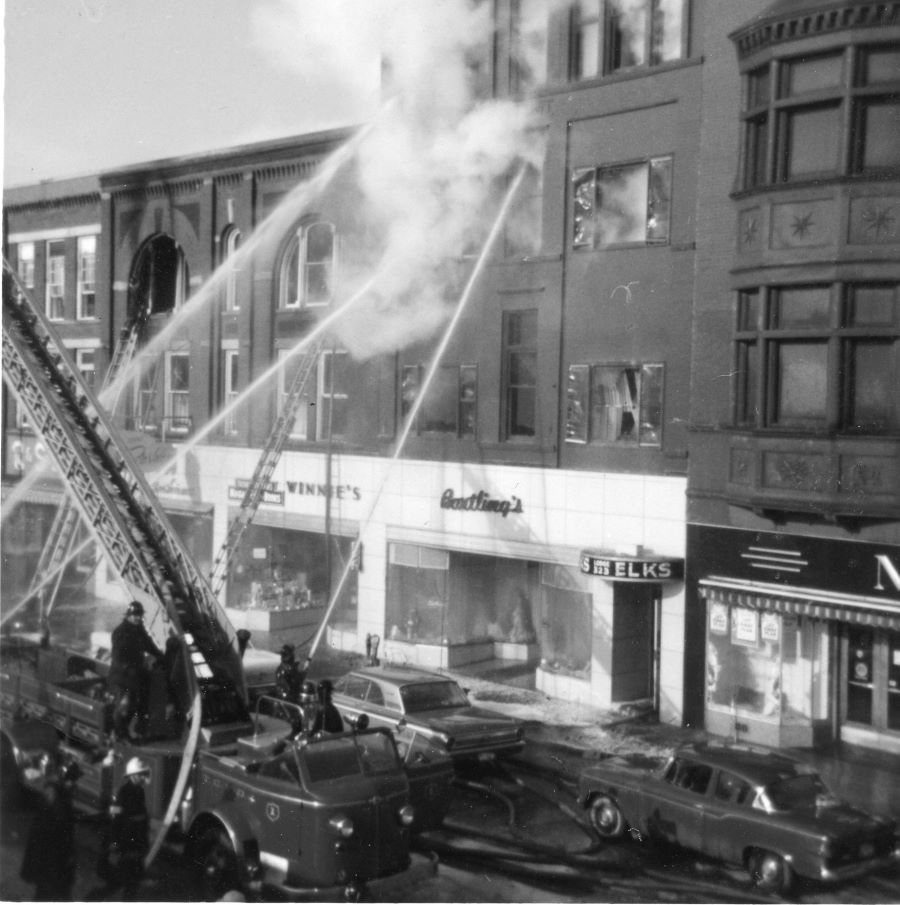 Photograph, elks club building on fire and Steinberg's right next door
