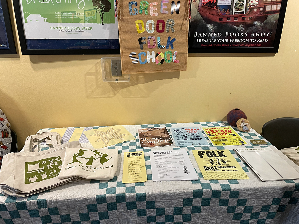 table with green quilt and papers
