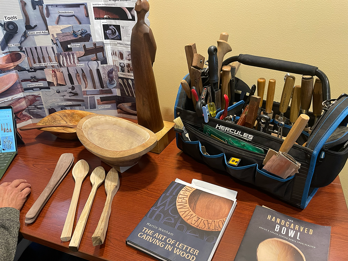 display of wood carving, tools, adn books