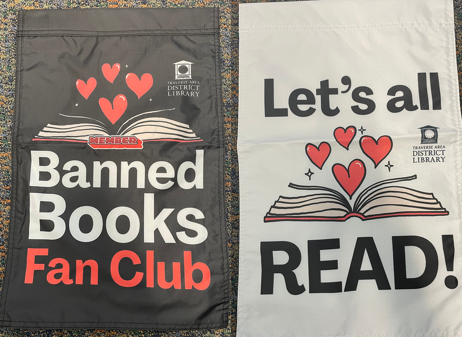 yard flags with banned books and let's all read