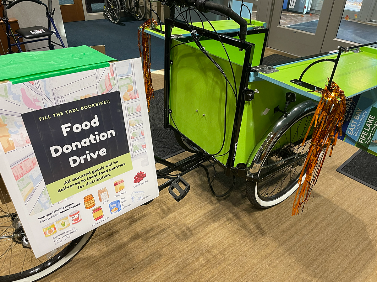 Book bike with food donation drive sign