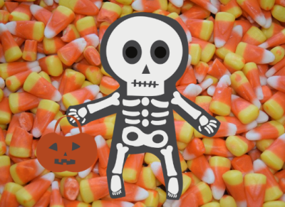 lil skeleton guy with a pumpkin trick or treat bucket on a background of candy corn