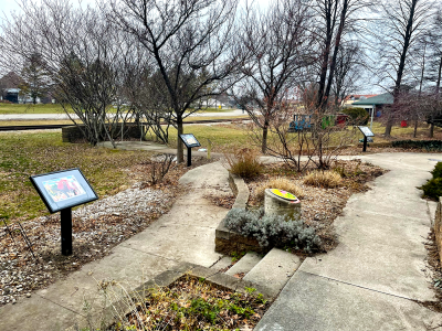 Storywalk boards following the garden path on the Main Library's west (lake) side