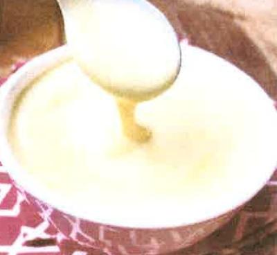 spoon dripping creme anglaise into bowl