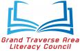 a stylized open book with blue page edges is over the red text of Grand Traverse Area Literacy Council