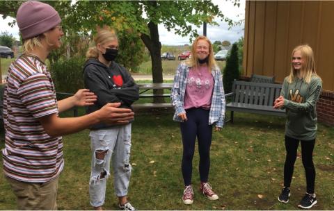 Four teens playing with improv.