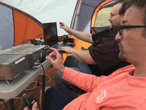 Two amateur radio enthusiasts with shortwave radio equipment