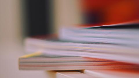 Photo of a stack of books with colorful paper covers