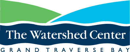 logo for The Watershed Grand Traverse Bay - two hills, green on left and blue on right with blue water at the base of the hills