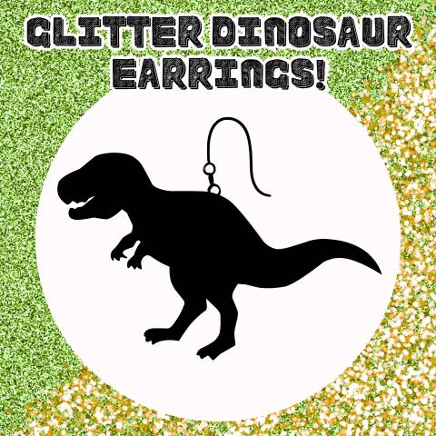Image of a T-Rex earring on a white circle, with green and gold glitter covering the background. It's titled: Glitter Dinosaur Earrings!