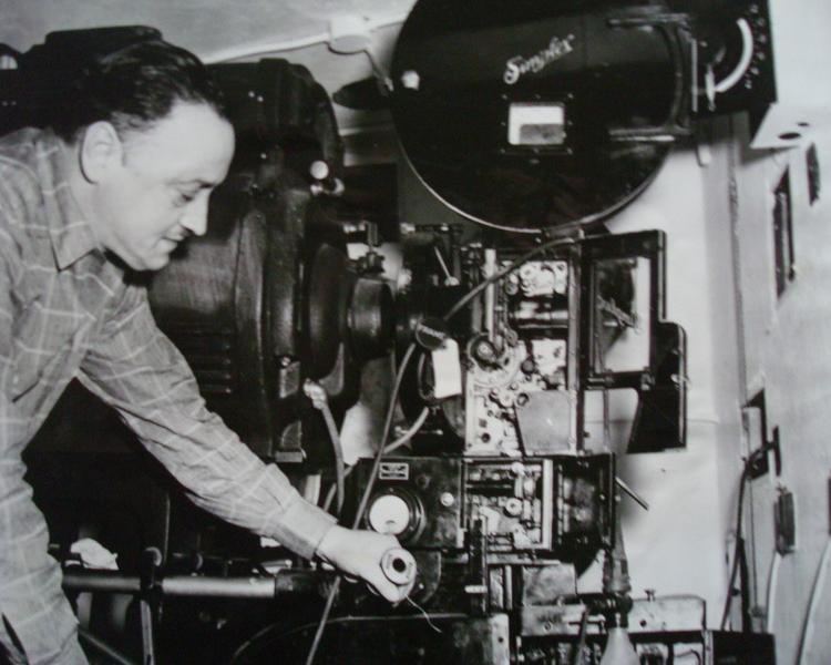 Black and white photo of a man with a camera