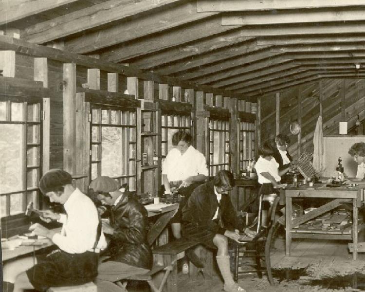 Black and white photo of people working in a production space
