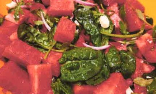 yellow dish filled with watermelon salad with feta