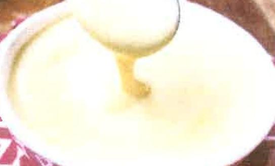 spoon dripping creme anglaise into bowl