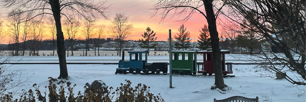 Wooden train outside the Main Library in the snow at sunset