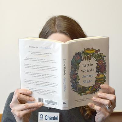 Headshot of Chantel Lentz, holding a book