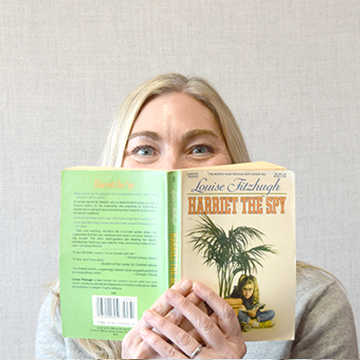 A headshot of Marika Bevier with a book